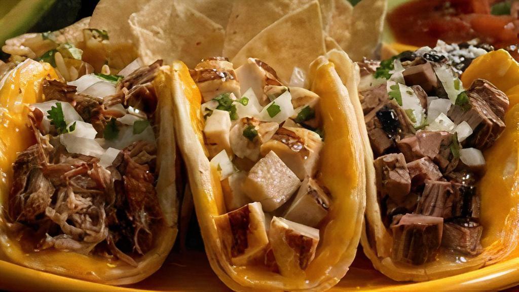 Mexico City Tacos · Three tacos, chicken, carne asada or carnitas in any combination, with rice, onions, cilantro, cheese, and beans.