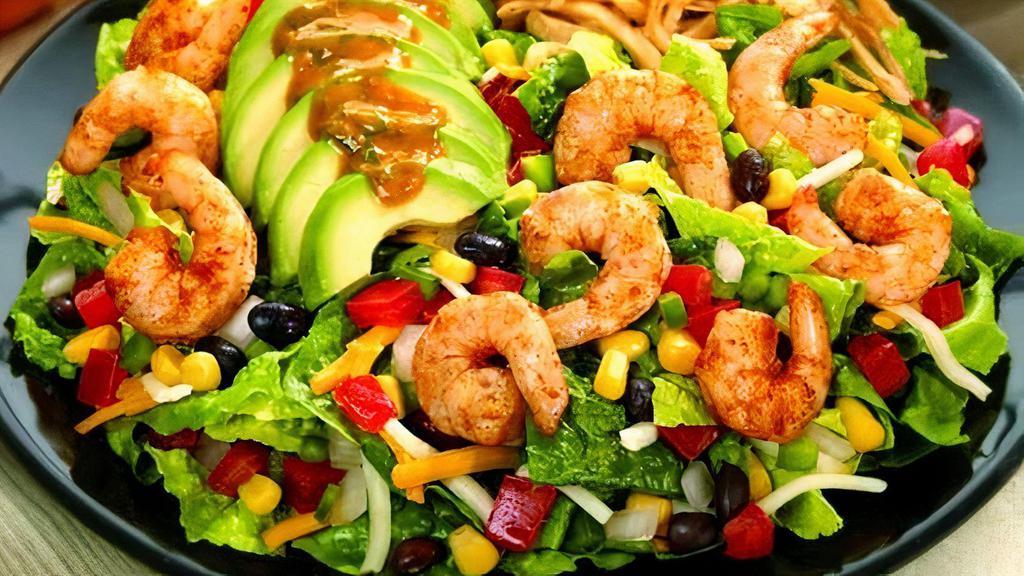 Chipotle Shrimp Salad · Grilled shrimp, romaine, avocado, beans and corn mix, salsa, cheese, tortilla strips, and chipotle dressing.