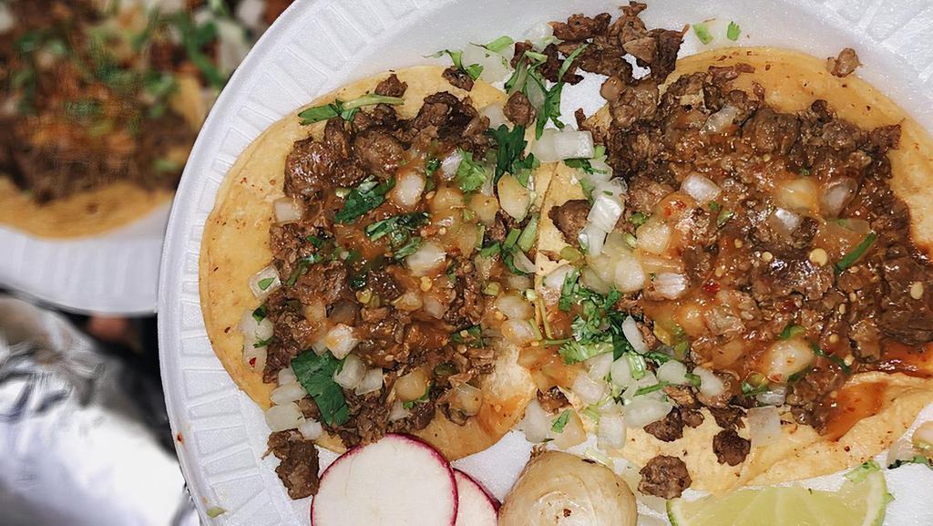 Tacos · Onions, cilantro, and salsa.