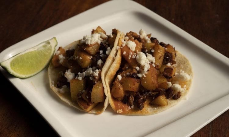 Chorizo con Papas Tacos · Two Mexican Pork Chorizo and Potato Tacos Topped with Arbol Salsa and Queso Fresco.  Our Tacos are Served on House-Made Corn Tortillas