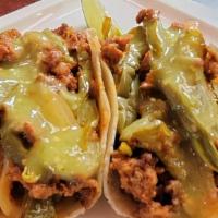 Nopales with Chorizo Tacos · Two Sauteed Cactus, Onions and Chorizo Tacos.  Topped with Mild Tomatillo Salsa.. Our Tacos ...