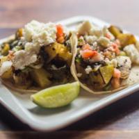 Papas con Rajas Tacos · Two Potato and Poblano Chili Tacos Topped with Salsa Fresca and Queso Fresco.  Our Tacos are...