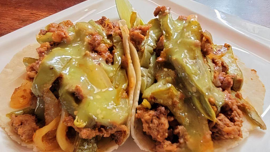 Nopales with Soyrizo Tacos · Two Sauteed Cactus, Onions and Soyrizo Tacos.  Topped with Mild Tomatillo Salsa.. Our Tacos are Served on House-Made Corn Tortillas