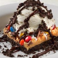 Peanut Butter Fudge Obsession · Layered peanut butter fudge, OREO® Cookie crust, topped with M&M’s, peanuts, chocolate shard...