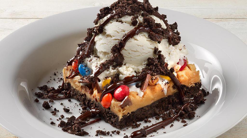 Peanut Butter Fudge Obsession · Layered peanut butter fudge, OREO® Cookie crust, topped with M&M’s, peanuts, chocolate shards, vanilla bean ice cream, chocolate sauce drizzle and OREO® Cookie crumbs.