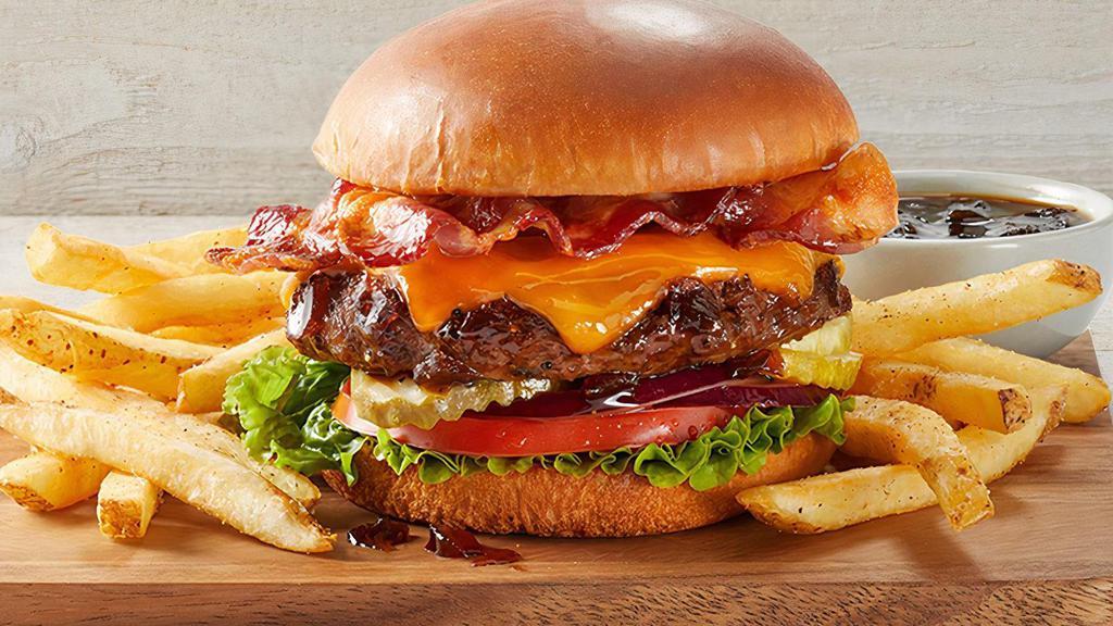 Fridays Signature Whiskey-Glazed Burger · Signature Whiskey-Glaze, bacon, cheddar, lettuce, red onions, tomato and  pickles.