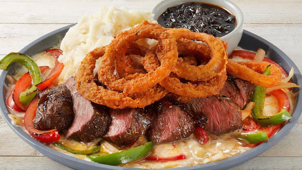 Sizzling Fridays Signature Whiskey-Glazed Flat Iron Steak · Soy-marinated flat iron steak, melted cheese, onions, red & green bell peppers, mashed potatoes, Cajun-spiced onion rings and Whiskey-Glaze on the side.