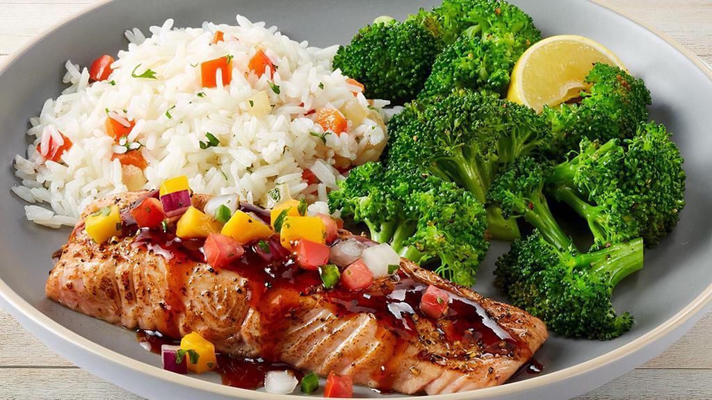 Dragon-Glaze Salmon · Sweet and spicy glazed salmon topped with a fresh mango pico. Served with lemon-butter broccoli and jasmine rice.