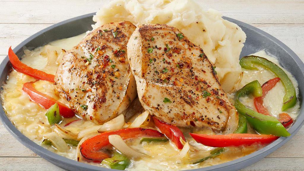 Sizzling Chicken & Cheese · Garlic-marinated chicken breasts served over melted cheese with onions, red & green bell peppers and mashed potatoes.