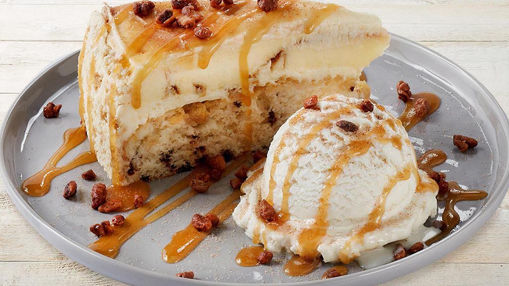 Cinnabon Caramel Pecan Cheesecake · Layers of Cinnabon cinnamon cheesecake and vanilla crunch cake topped with signature cream cheese frosting, caramel and glazed pecans. Served with vanilla bean ice cream.