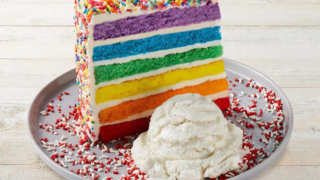 Carlo'S Bakery Rainbow Cake · Six layers of rainbow-colored vanilla cake filled high with a sweet vanilla icing and covered with rainbow sprinkles. Served with vanilla bean ice cream.