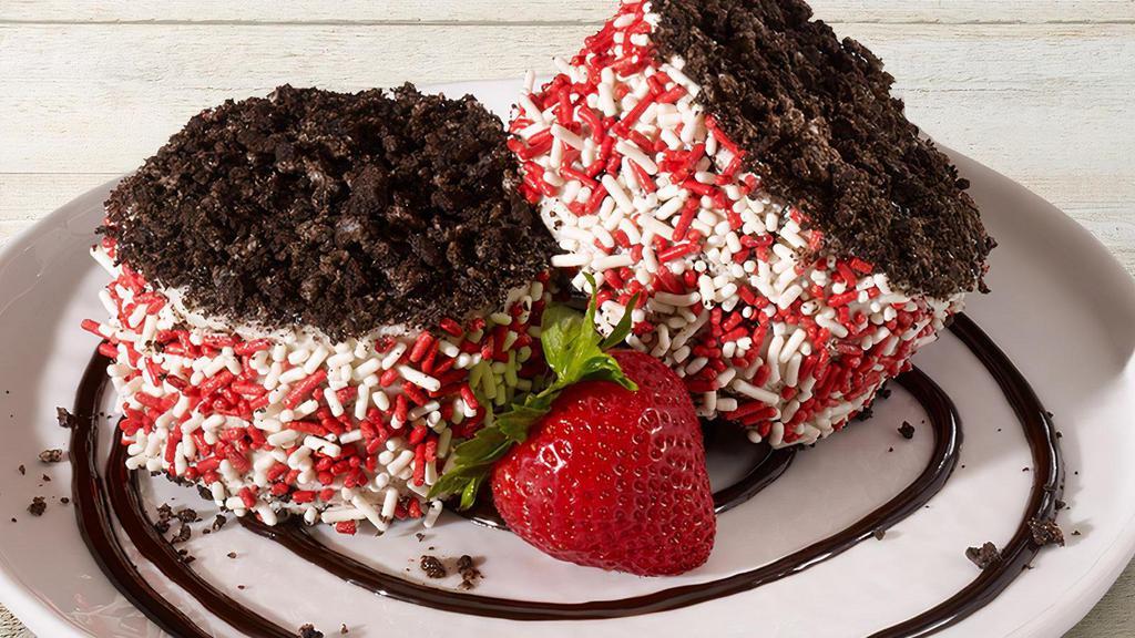 Oreo® Madness - Fully Stuffed · Better than ever! House-made giant OREO® cookies with Cookies & Cream ice cream, coated in red & white sprinkles.  Served with chocolate sauce and a fresh strawberry.