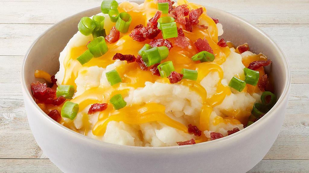 Loaded Mashed Potatoes · Creamy mashed potatoes blended with cheddar cheese, sour cream and real butter. Topped with more cheese and bacon.