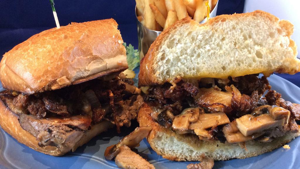 Smoke House Tri Tip · Fresh roasted tri tip with melted cheddar cheese, mushrooms and BBQ sauce topped with house made onion strings on a roll.