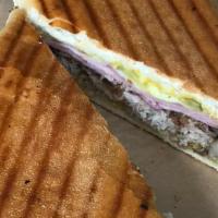 Traditional Cuban Sandwich · Pernil Oven Roasted pork, ham, Swiss, pickles, and mustard.