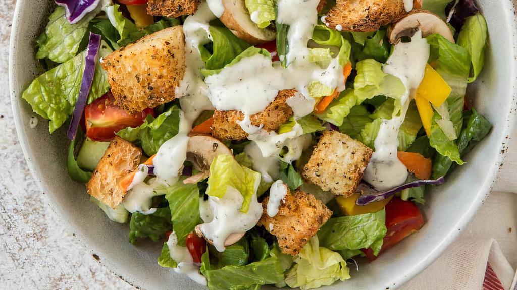 Garden Salad · Locally grown greens, Roma tomatoes, and cucumbers topped with crunchy croutons with a side of dressing.