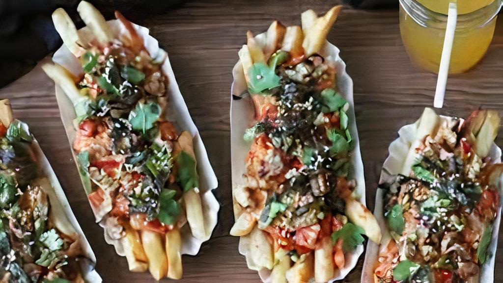 Korean Fries · Grilled bulgogi-steak, caramelized kimchi, cheddar cheese-yes cheddar cheese, samourai sauce, green onions, and sesame seeds.