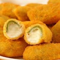 Jalapeño Poppers · Jalapeño poppers stuffed with cream and served with marinara sauce.
