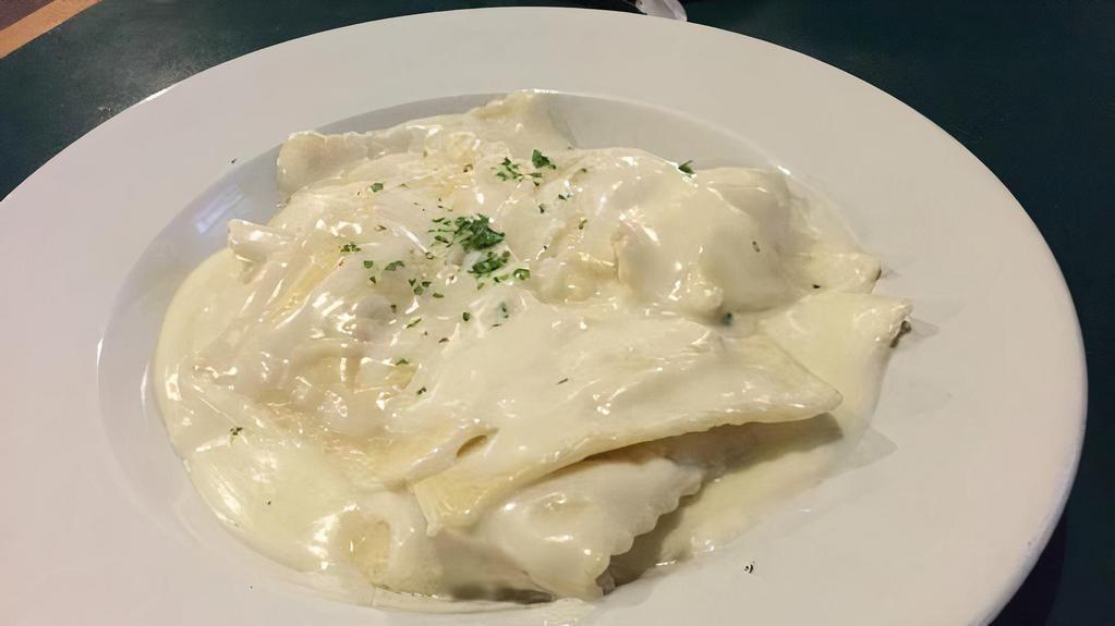Cheese Ravioli with Alfredo · Ravioli stuffed with cheese, topped with our homemade alfredo sauce.
