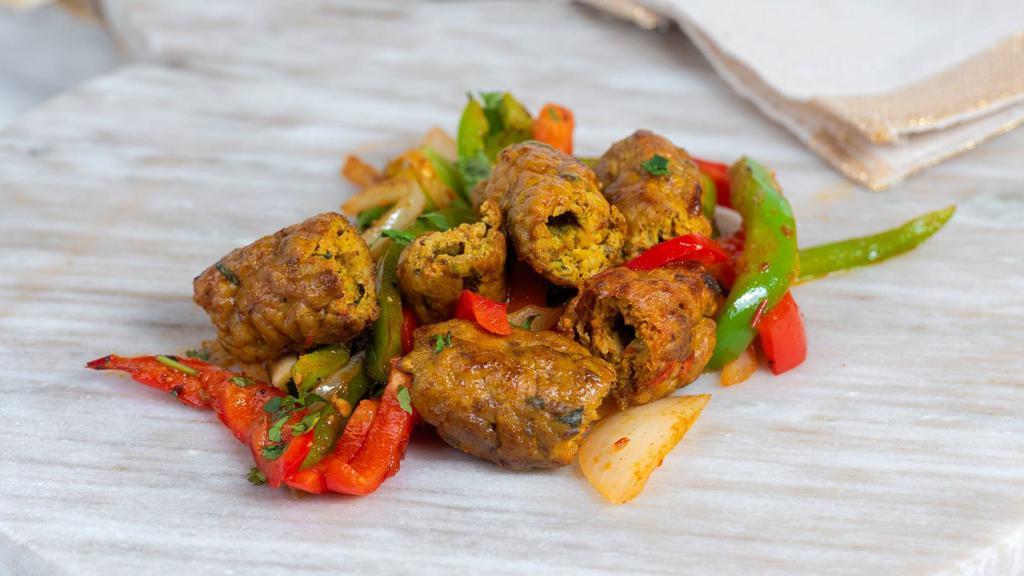 Chicken Seekh Kebab · Ground chicken mixed with spices, shaped on the seekh and baked in the tandoor oven.