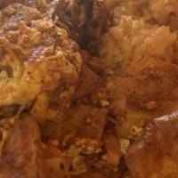 Chilaquiles · Tortilla chips scrambled eggs in a spicy sauce. Includes rice, beans, flour, or corn tortill...