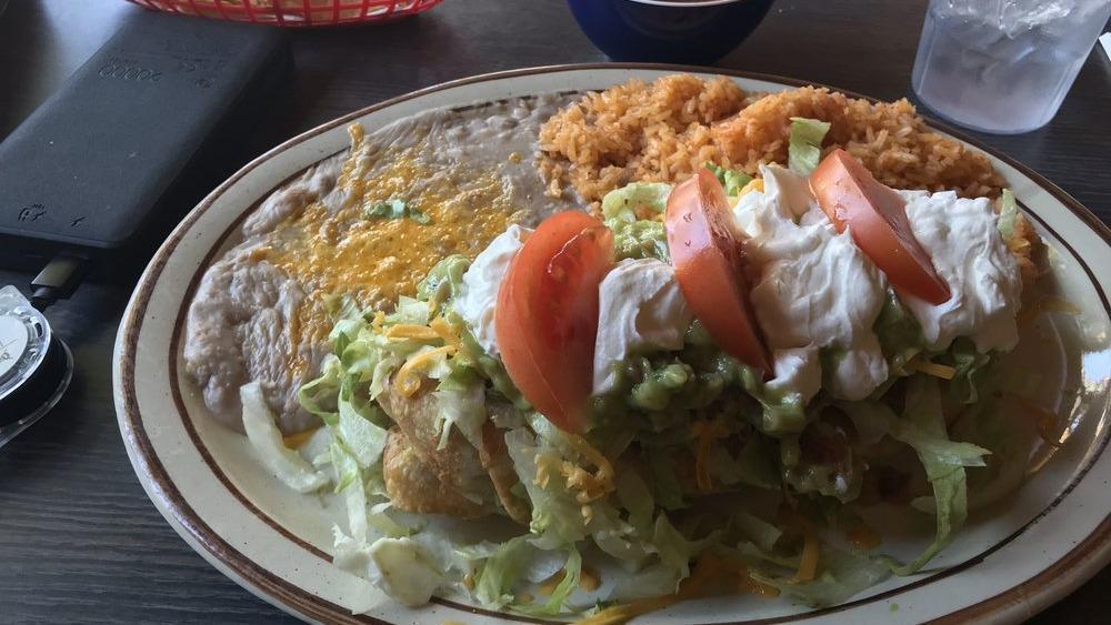 Chimichanga · Flour tortilla stuffed with pork, beef, or chicken, deep fried to golden brown and topped with lettuce, cheese, guacamole, sour cream, and tomatoes. Served with rice and refried beans.