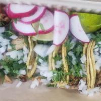 Taco plate pastor  · 4 tacos with cilantro and onions ,
Radishes ,limes