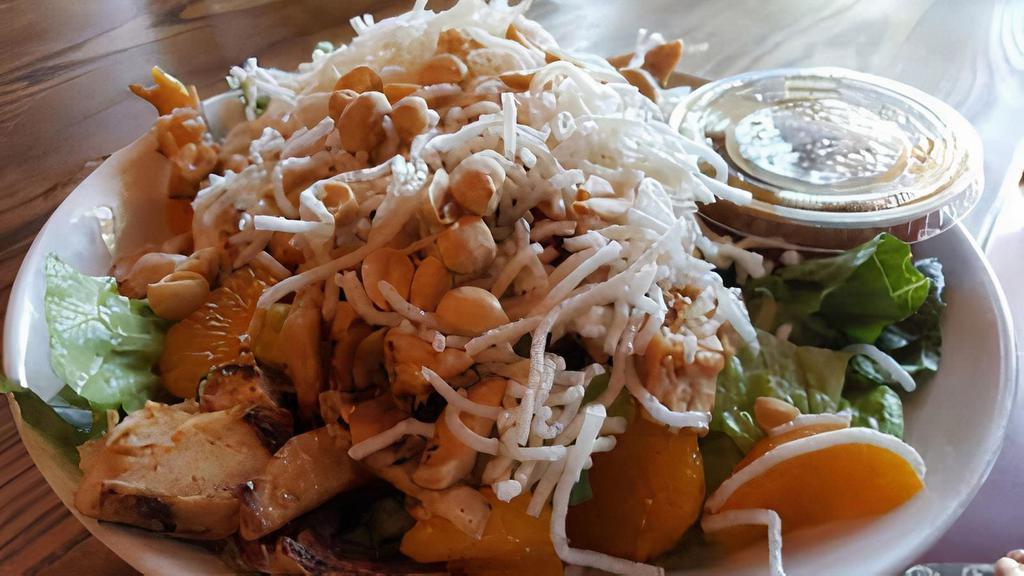 Asian Chicken Salad · Grilled Chicken Breast, Romaine Lettuce, Mandarin Oranges, Peanuts, Crisp Rice Noodles served with Sesame Dressing on the side.