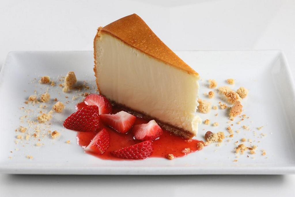 New York Style Cheesecake · shortbread crust, decadent cheesecake, fresh strawberries
