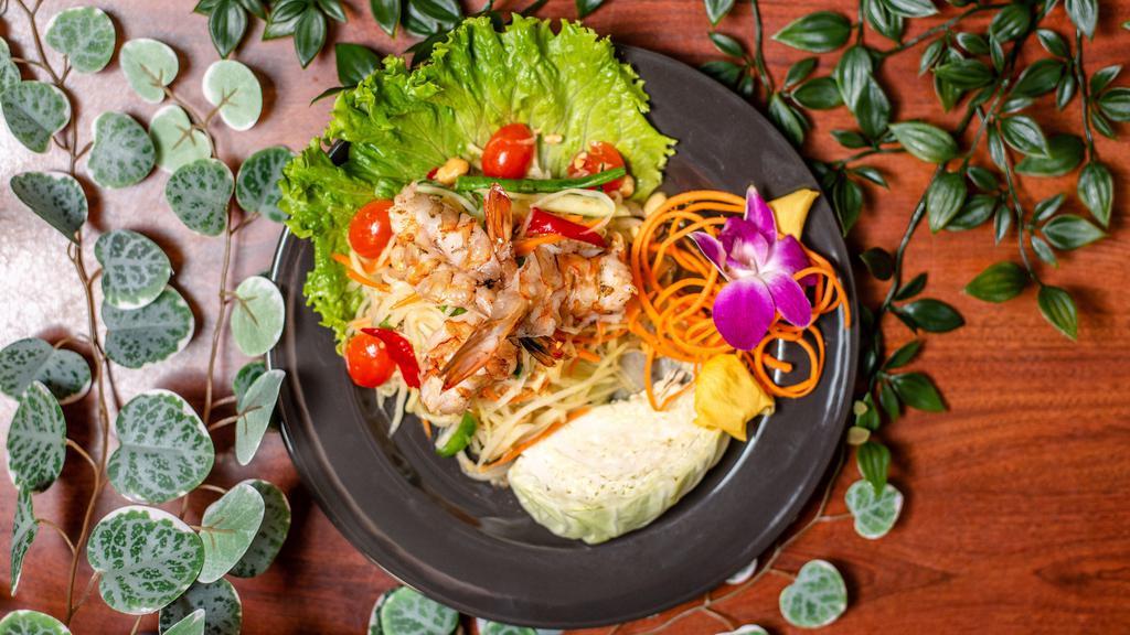 Papaya Salad · Shredded green papaya, ground peanut, tomatoes, garlic, chili, carrots, and green beans in chili and lime dressing. Add grilled shrimp for an additional charge.