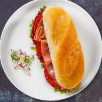 Classic Italian Sub · Ham, salami, pepperoni, Italian dressing, swiss cheese, lettuce, and tomato on a bread.