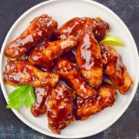 Cookout Wings · Fresh chicken wings breaded and fried until golden brown and tossed in BBQ sauce. Served wit...