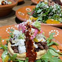 Sopes · 2 Sopes -Fried Masa Crust, Beef Brisket / Pickled Cabbage/
Pickled Onions/ Guacamole/ Guajil...