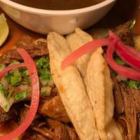 Quesabirria Taco · Hand Made Tortilla/ Braised Beef/ Cilantro/ Onions/ Red Salsa/ Birria Jus
 GF