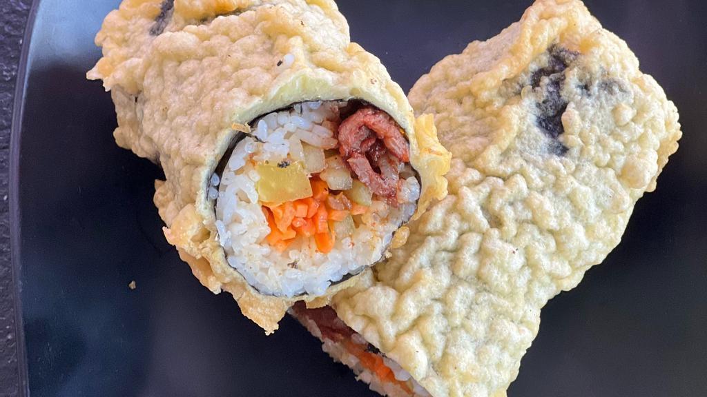 Fried Bulgogi Kimbap · Comes with two fried rolls cut into bite sizes. Marinated Bulgogi, radish, carrots, fish cake, and touch of sesame oil. (picture shown 1 roll cut in half)