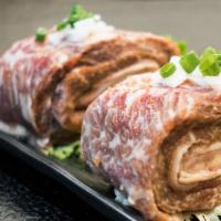 Traditional-Cut Marinated Galbi (1 roll) (Uncooked) 生 一卷 · One roll of traditional-cut premium galbi.