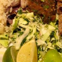 Poc Chuc · Grilled citrus marinated pork served with vegetable-bouillon rice, topped with grilled red o...