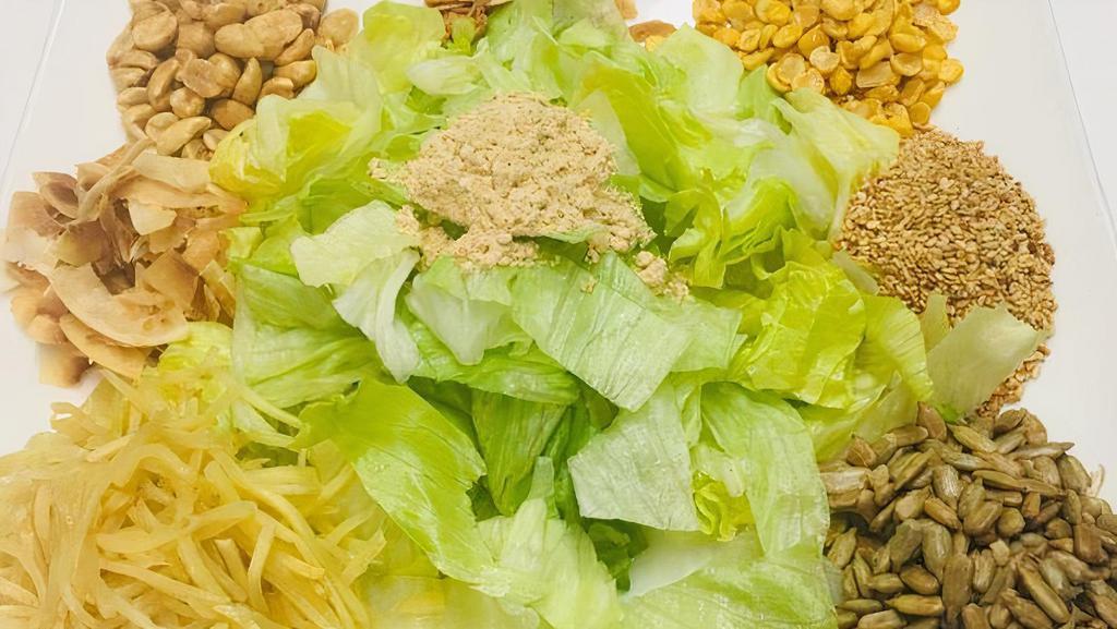 Ginger Salad · Salad prepared with shredded ginger, fried garlic, sesame seeds, lettuce, peanuts and fried split peas.