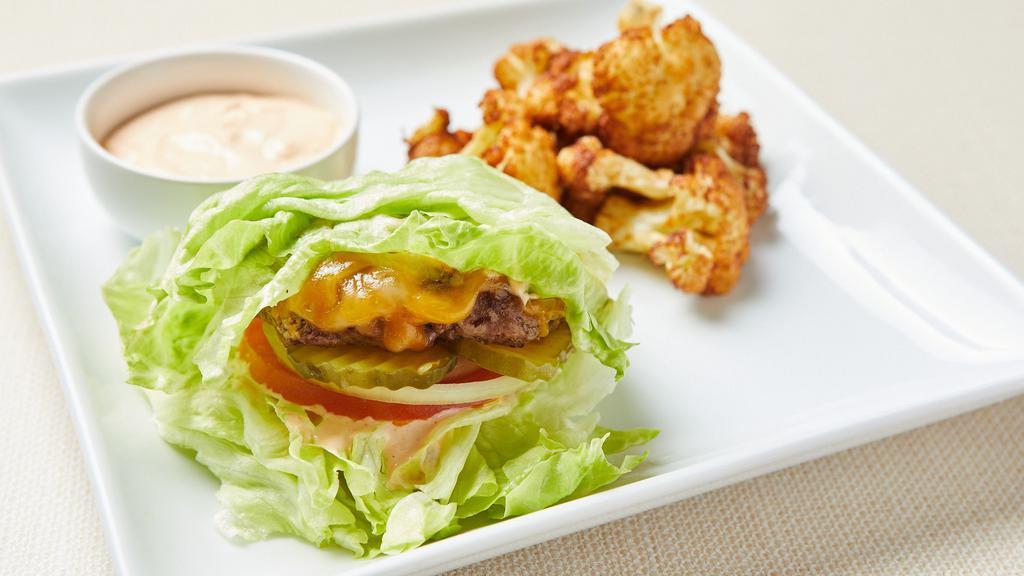 GF Lettuce Wrapped Beyond Burger (V) · Lettuce wrapped fresh grilled seasoned Beyond (plant-based) patty, vegan cheddar, tomato, onion and pickles. Served with fried cauliflower and vegan chipotle aioli. Gluten-free. Vegan.