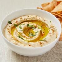 Hummus · Homemade chickpea hummus with tahini, olive oil, garlic and cumin. Served with gluten-free c...