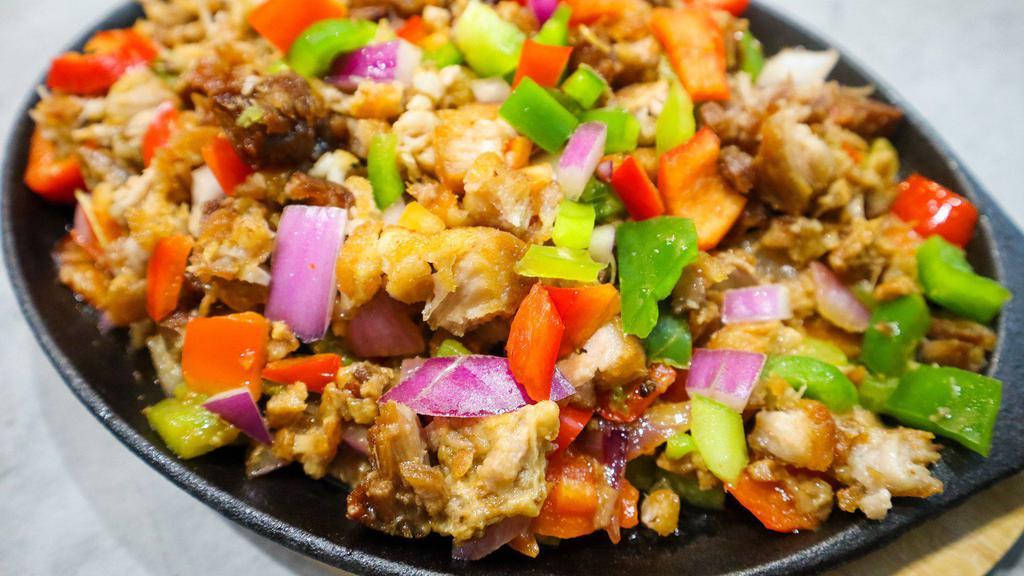 Sisig · Marinated Pork Belly served with Green Peppers, Red Peppers and Red Onions.