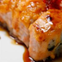 3. Lion King Roll · Baked California roll topped with salmon, tobiko and creamy sauce.