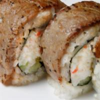 2. BBQ Roll · Shrimp tempura, crab meat and cucumber topped with torched marinated steak.