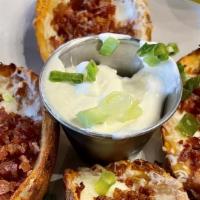 Crispy Potato Skins · Cheese, bacon, green onions & side of sour cream or ranch.