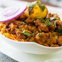 Boneless Chicken Biryani · Boneless chicken cooked with a house special sauce with cashew nuts and spices served with c...