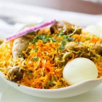 Chicken Dum Biryani · Succulent Chicken cooked with spices and aromatic basmati rice.