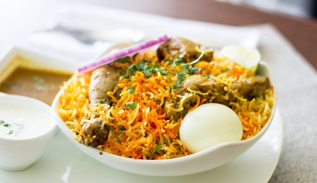 Chicken Dum Biryani · Succulent Chicken cooked with spices and aromatic basmati rice.