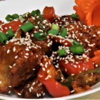 Sesame chicken · Battered fried chicken sautéed in sauce, spices, onions and chilies topped off with sesame s...