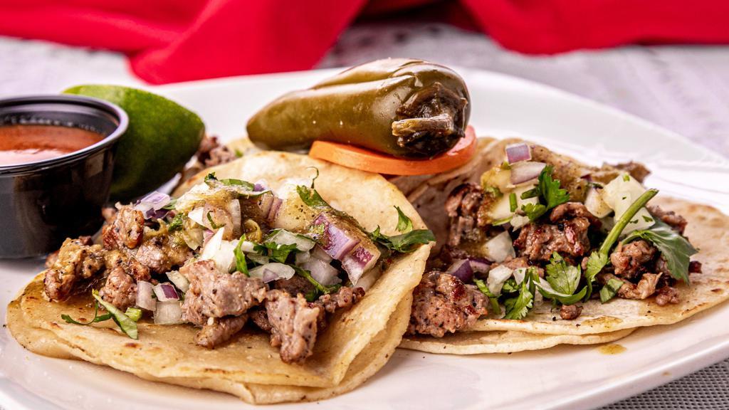 Tacos with Beef, Chicken, or Spiced Pork · 