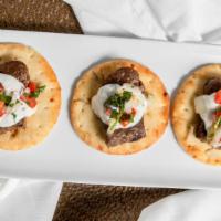 Mini Gyros (3 Pcs.) · Warm buttery pita with beef gyro  topped with dill tzatziki sauce and chopped salata